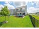 Large backyard featuring a well-maintained lawn, a gazebo with outdoor seating, and a black metal fence at 1026 Woodglen Dr, Westfield, IN 46074