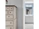 Bright bathroom featuring a wooden cabinet, neutral paint, and open doorway to a white vanity and mirror at 1026 Woodglen Dr, Westfield, IN 46074