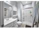 Bright bathroom features white vanity, toilet, glass shower, and neutral walls at 1026 Woodglen Dr, Westfield, IN 46074