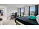 Bright bedroom featuring two windows, a desk, a gaming chair, and neutral walls at 1026 Woodglen Dr, Westfield, IN 46074