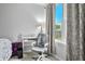 Cozy bedroom featuring a desk, white chair, and a view of the neighborhood at 1026 Woodglen Dr, Westfield, IN 46074