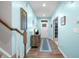 Bright entryway with hardwood floors, light blue walls, and staircase leading to the upper level at 1026 Woodglen Dr, Westfield, IN 46074