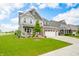 Attractive two-story home boasts a covered front porch, stone accents, and well-manicured landscaping at 1026 Woodglen Dr, Westfield, IN 46074