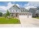 Charming two-story home featuring stone accents, a welcoming porch, and a three-car attached garage at 1026 Woodglen Dr, Westfield, IN 46074