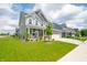 Attractive two-story home boasts a covered front porch, stone accents, and well-manicured landscaping at 1026 Woodglen Dr, Westfield, IN 46074