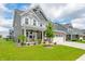 Attractive two-story home boasts a covered front porch, stone accents, and well-manicured landscaping at 1026 Woodglen Dr, Westfield, IN 46074