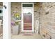 Inviting front porch featuring stone detailing, a welcoming entrance, and a cozy seating area at 1026 Woodglen Dr, Westfield, IN 46074