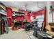 Organized garage featuring ample storage, a workbench, and motorcycle, suitable for DIY projects and vehicle maintenance at 1026 Woodglen Dr, Westfield, IN 46074