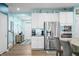 Kitchen area featuring stainless steel appliances, light wood floors, and lots of natural light from nearby doors and windows at 1026 Woodglen Dr, Westfield, IN 46074