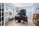 Bright office with neutral carpet and large window, featuring a large desk and shelving at 1026 Woodglen Dr, Westfield, IN 46074