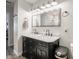Bathroom featuring a double sink vanity with marble countertops and modern fixtures at 10443 Ringtail Pl, Fishers, IN 46038