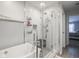 Bathroom featuring a tub to shower with subway tile and white accents at 10443 Ringtail Pl, Fishers, IN 46038