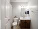 Bathroom featuring a single sink vanity, mirror, and neutral accents at 10443 Ringtail Pl, Fishers, IN 46038