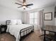 Bedroom with neutral decor, ceiling fan, dark accents, and large windows at 10443 Ringtail Pl, Fishers, IN 46038