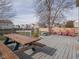Enjoy the outdoors from this spacious deck with a picnic table, benches, and chairs overlooking a fenced yard at 10443 Ringtail Pl, Fishers, IN 46038