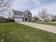 Attractive two-story home with a two-car garage, a well-kept lawn, and a charming front porch at 10443 Ringtail Pl, Fishers, IN 46038