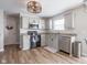 Well-equipped kitchen features stainless appliances, granite countertops, and stylish light fixtures at 10443 Ringtail Pl, Fishers, IN 46038