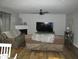 Spacious living room featuring a fireplace, ceiling fan and hardwood floors at 10443 Ringtail Pl, Fishers, IN 46038