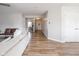 Bright living room with hardwood floors and a view of an office and the front entry at 10443 Ringtail Pl, Fishers, IN 46038