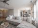 Inviting living room with an oversized sofa that looks into the kitchen and dining area at 10443 Ringtail Pl, Fishers, IN 46038