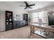 Well-lit office space with neutral walls, a large desk, ample storage, and a ceiling fan at 10443 Ringtail Pl, Fishers, IN 46038