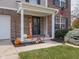 Close-up of a welcoming front porch adorned with seasonal decorations and charming details at 10443 Ringtail Pl, Fishers, IN 46038