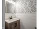 Stylish powder room with modern vanity, shiplap accents, and patterned wallpaper at 10443 Ringtail Pl, Fishers, IN 46038