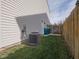 Practical side yard with a wooden fence, air conditioning unit, and convenient access at 10443 Ringtail Pl, Fishers, IN 46038