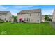 Spacious backyard featuring green grass and an inviting patio with outdoor seating and a grill at 10515 Sugar Ridge Way, Indianapolis, IN 46239