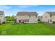 Large grassy backyard, great for entertaining or relaxing with a patio and outdoor furniture at 10515 Sugar Ridge Way, Indianapolis, IN 46239