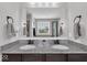 This bathroom features a granite topped dual vanity and black fixtures at 10515 Sugar Ridge Way, Indianapolis, IN 46239