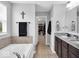 This bathroom features a granite topped vanity, soaking tub and access to the closet at 10515 Sugar Ridge Way, Indianapolis, IN 46239