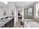 This bathroom features a granite topped vanity, soaking tub and access to the shower at 10515 Sugar Ridge Way, Indianapolis, IN 46239