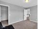 Spacious bedroom with neutral walls and carpet, features an open door to the hallway at 10515 Sugar Ridge Way, Indianapolis, IN 46239
