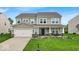 Charming two-story home with manicured lawn and inviting front porch at 10515 Sugar Ridge Way, Indianapolis, IN 46239