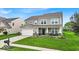 Charming two-story home with manicured lawn and inviting front porch at 10515 Sugar Ridge Way, Indianapolis, IN 46239