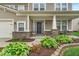 A welcoming front porch with lush landscaping and inviting seating at 10515 Sugar Ridge Way, Indianapolis, IN 46239