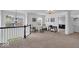 Bright loft space featuring neutral carpet, black and white banisters and chair seating at 10515 Sugar Ridge Way, Indianapolis, IN 46239