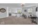 A spacious loft area with neutral carpet, a desk, and comfortable seating at 10515 Sugar Ridge Way, Indianapolis, IN 46239