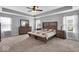 This main bedroom features an inviting bed, recessed ceilings, carpeted floors and is brightly lit at 10515 Sugar Ridge Way, Indianapolis, IN 46239