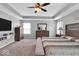 Bright and spacious main bedroom boasts carpeted floors, a ceiling fan and a trey ceiling at 10515 Sugar Ridge Way, Indianapolis, IN 46239