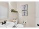 Well-lit powder room featuring a vessel sink, modern fixtures, and stylish decor at 10515 Sugar Ridge Way, Indianapolis, IN 46239