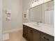 Bathroom featuring a dark-wood vanity, white countertop, and a decorative mirror with an ivy accent at 10655 E 200 S, Zionsville, IN 46077