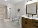 Stylish bathroom with a wood vanity, sink, framed mirror, and a glass shower door at 10655 E 200 S, Zionsville, IN 46077