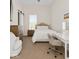 Bright bedroom with a tufted headboard bed, vanity, and large window for ample natural light at 10655 E 200 S, Zionsville, IN 46077