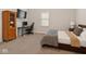 Cozy bedroom with a plush bed, desk setup, and a large window providing natural light at 10655 E 200 S, Zionsville, IN 46077