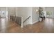 Upstairs hallway with wood floors, a wooden banister, and double front doors at 10655 E 200 S, Zionsville, IN 46077