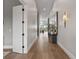 Hallway with light hardwood floors, white trim, decor, and white doors at 10655 E 200 S, Zionsville, IN 46077