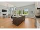 Bright kitchen with hardwood flooring, large windows, and center island with bar seating at 10655 E 200 S, Zionsville, IN 46077