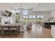 Bright open-concept living room featuring large windows with scenic views and hardwood flooring at 10655 E 200 S, Zionsville, IN 46077